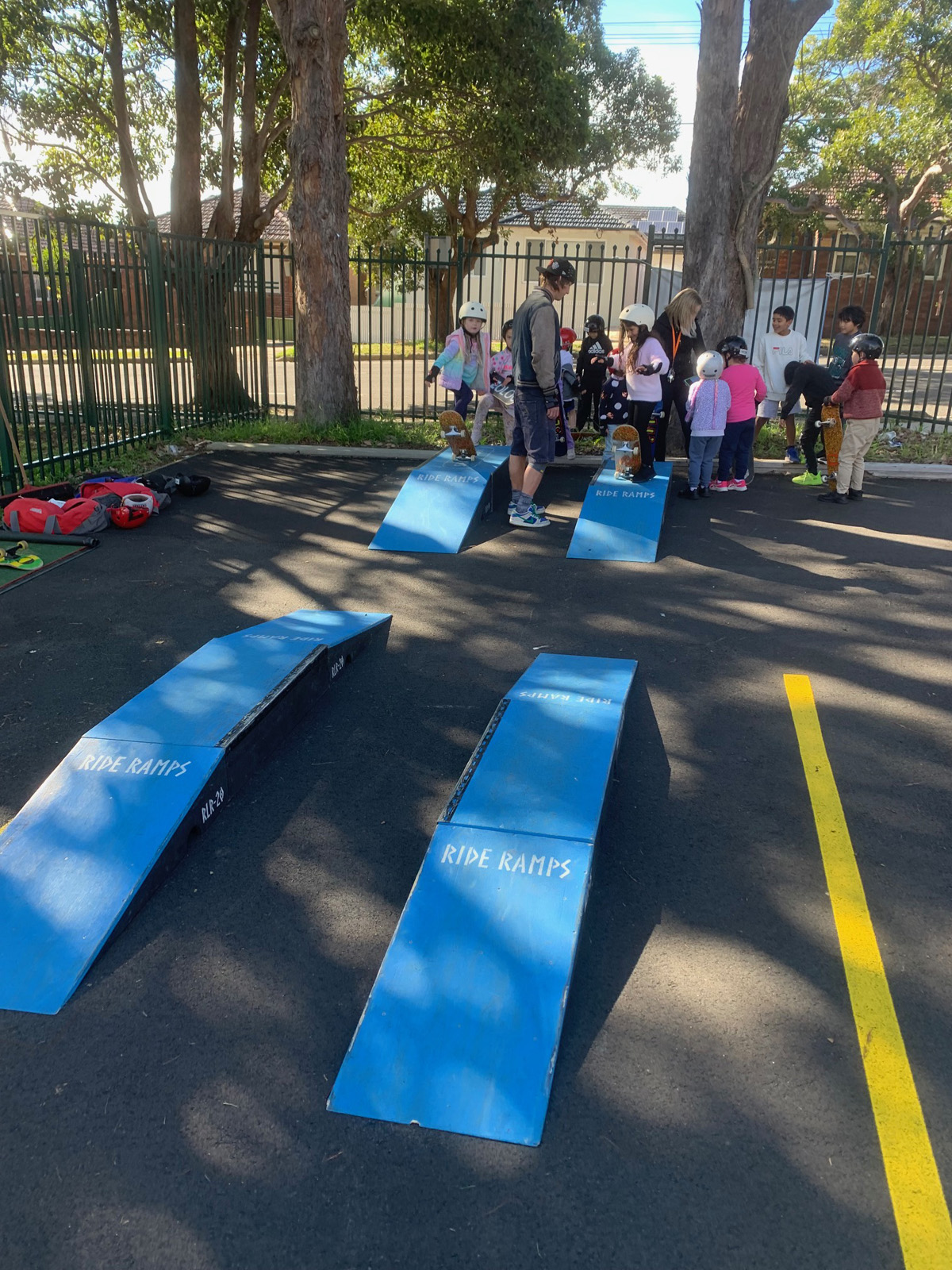 Kids skateboarding with blue skate ramps